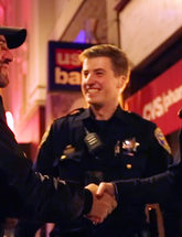 SFPD Female and Male Officer Shaking Hands with Man On Street