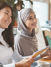 Group of People At Desk in a Community Meeting