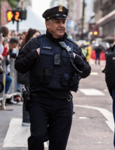 Image of police officers walking along street standing side-by-side