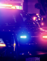 Image of patrol vehicle with emergency lights activated.