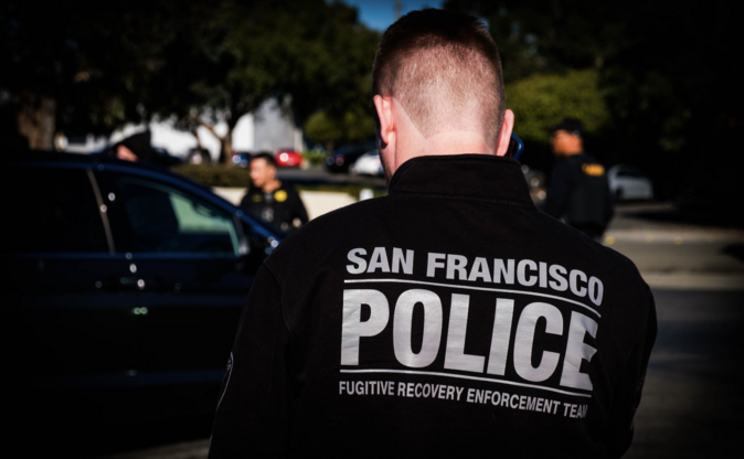 Image of officer standing at scene with blurred background