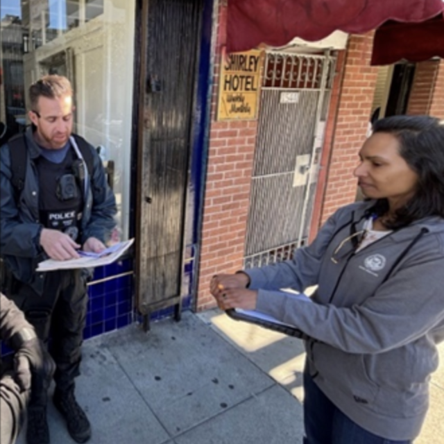 image of officers collaborating with member of city department