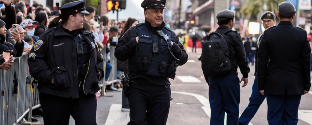Image of police officers walking along street standing side-by-side